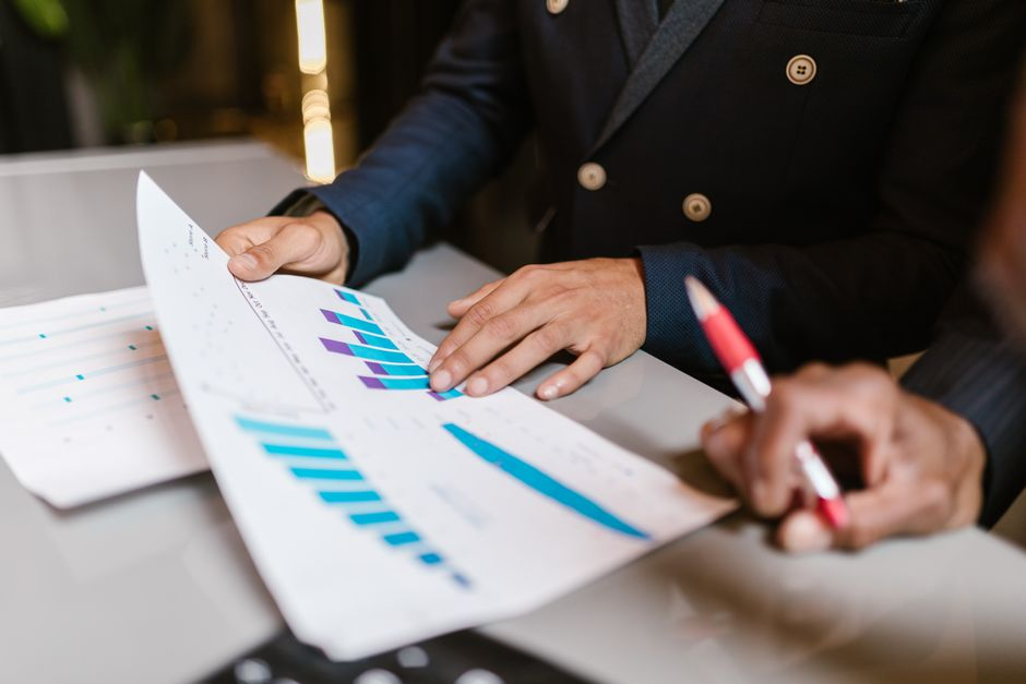Advisors and business owners preparing for a self-led M&A sale process with financial and legal documentation